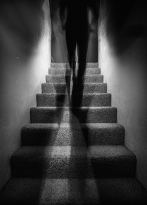 shadowy man walking up stairs